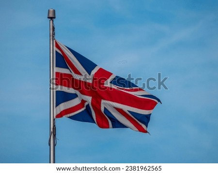 Union Jack, the National Flag of the United Kingdom on a flag pole, flying in the breeze, red, white and blue, Great Britain