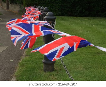 Union Jacks Flutter On An English Village Green 