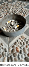 unique cigarette ashtray on patterned tiles