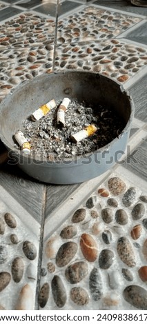 unique cigarette ashtray on patterned tiles