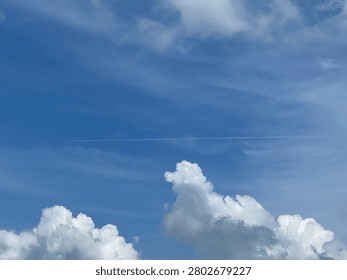 Unique composition showing a glimpse of deep blue through white clouds.