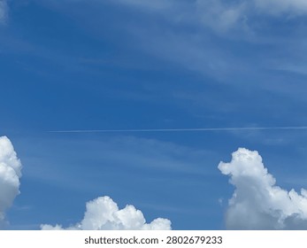 Unique composition showing a glimpse of deep blue through white clouds.