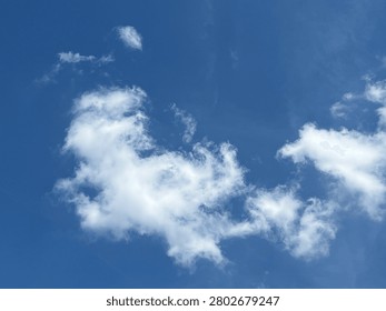 Unique composition showing a glimpse of deep blue through white clouds.