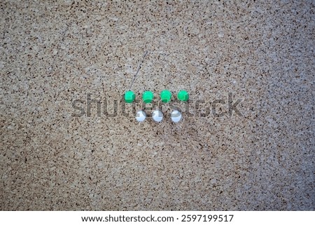 Unique composition symbolize teamwork, precision, and a structured mindset. Green pins represent growth and innovation, while the white pins symbolize clarity and simplicity.