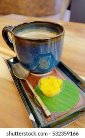 Unique design value added latte coffee in a cup and the traditional desert on wood table served in coffee shop in the morning or coffee time with very romantic environment for friends or lovers time 