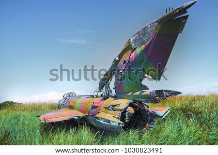 Unique foto. war plane crashed on shore of sea several years ago and lies on grassy dunes. Different camera angles at different times