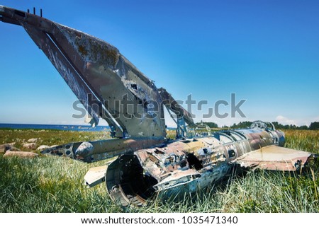 Unique foto. war plane crashed on shore of sea several years ago and lies on grassy dunes. Different camera angles at different times
