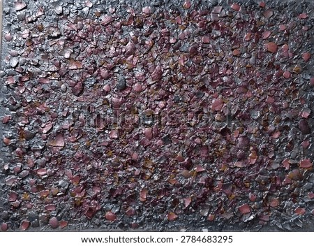 A unique handmade eggshell craft featuring small crushed pieces arranged into a textured mosaic pattern. The combination of dark purple, reddish, and black tones creates an artistic and eye-catching surface with rich detail. The glossy finish enhances the natural texture of the eggshell fragments, making the artwork look creative, elegant, and visually striking.