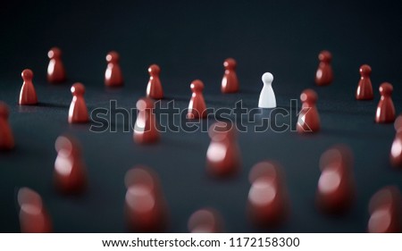 Unique individual standing out in crowd. Leadership, uniqueness and winning competitors. Originality, independence, difference or loneliness concept. One different color board game pawn. 