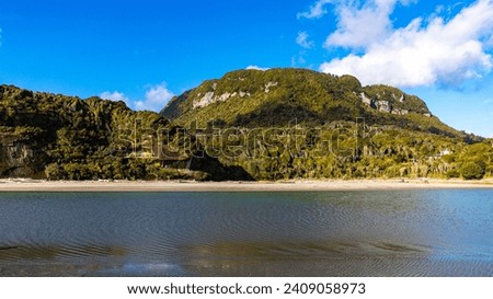 unique landscape of pororari lagoon near punakaiki, new zealand south island west coast, beautiful beach with mouth of river surrounded by rainforest