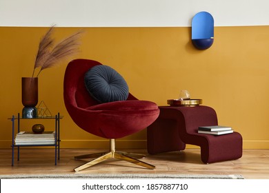 Unique living room in modern style interior with mock up poster frame,  design red velvet armchair,  elegant furniture, decoration and pesronal accessories in home decor. Honey yellow wall. Template.