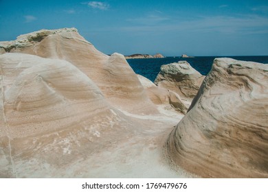 A Unique Perspective Of The Landscape Of Sarakiniko Beach On The Greek Island Of Milos Overlooking The Aegean Sea