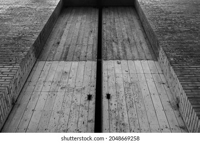 Unique Perspective Of Large Door On A Old Abandoned Brick Building