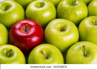 Unique. Red apple among group of green apples.