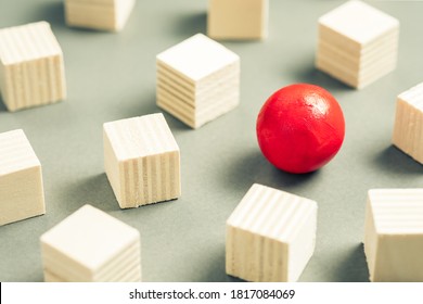 Unique Red Sphere In A Group Of Sqaure Cubes, Small Wooden Objects For Design And Carpentry Work, Different And Unique, Positioning For Advertising And Business Concept