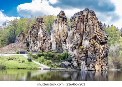 Unique rock formation Externsteine near Detmold, Nordrhein-Westfalen, Teutoburger Wald, Germany, view from the side of the lake - Shutterstock ID 2164657201