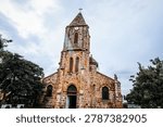 unique rustic stone architecture and clock tower of the Cathedral of Our Lady of Mount Carmel built in 1902.