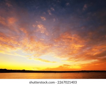 Unique sunset on the river bank with red clouds - Shutterstock ID 2267021403