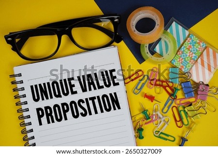 Unique Value Proposition text with eyeglasses and stationery on yellow background