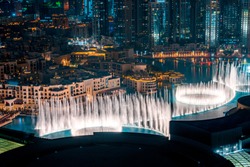 Unique View Of Dubai Dancing Fountain Show At Night. Tourist Attraction. Luxury Travel Destination. 
