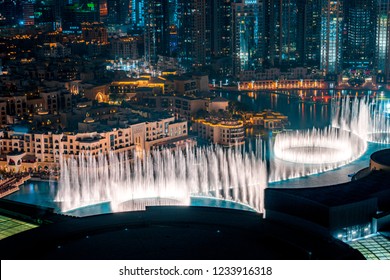 Unique view of Dubai Dancing Fountain show at night. Tourist attraction. Luxury travel destination. 