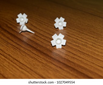 Unique white flower shape objects kept on a wooden table isolated stock photograph