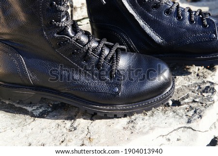 Unisex black boots army with zipped laces on the street. Caucasus, Russia