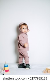 Unisex Clothes For Babies. Cute Baby In Cotton Set Suit On Light Background. Kids Fashion