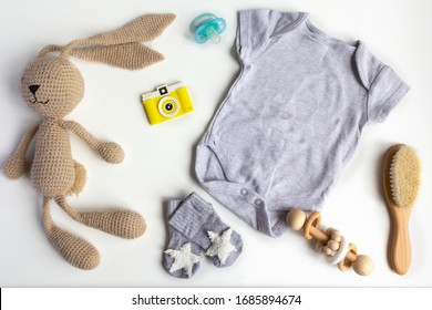 Unisex Neutral Theme With Baby Shower Or Newborn Nursery Concept With Clothes, Toys, Accessories On White Background. Flat Lay, Top View.