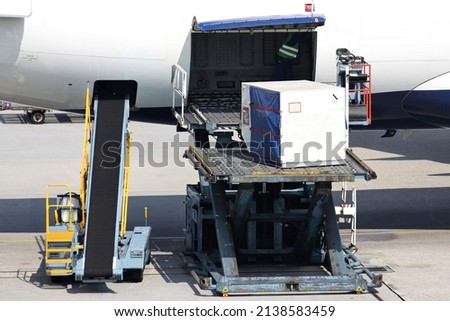 unit load devices being loaded into airliner at international airport