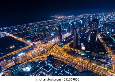 United Arab Emirates Dubai 07/14/2014 downtown dubai futuristic city neon lights and sheik zayed road shot from the worlds tallest tower building in Dubai - Shutterstock ID 351869855