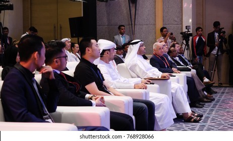 United Arab Emirates, Dubai - October 2017: Business Partners Discussing Documents And Ideas At Meeting. Conference Blockchain In Dubai