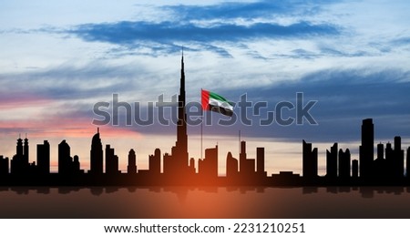 United Arab Emirates flag and Dubai skyline view at sunset. UAE celebration. National day, Flag day, Commemoration day, Martyrs day.