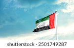 United Arab Emirates national flag fluttering. The flag blowing in beautiful soft sky. UAE national flag for independence day.