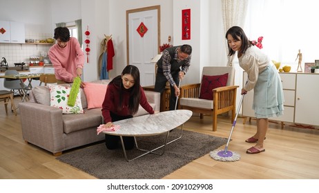 united chinese family members working together doing spring cleaning. mopping floor. wiping table. dusting furniture at home for chinese new year. translation: spring and congratulations everyone - Shutterstock ID 2091029908