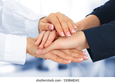 United hands, on office background - Shutterstock ID 150868241