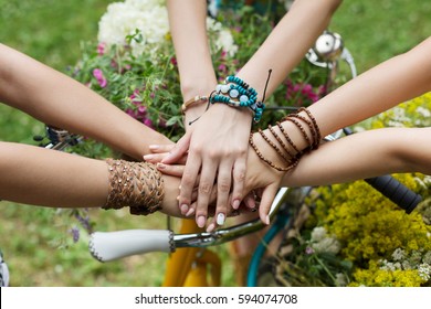 United Hands Of Young Females. Stylish Girlfriends In Boho Hippie Bracelets Near Bicycle Handlebar, Top View. Togetherness And Support, Youth Fashion And Active Lesiure. Women Friendship