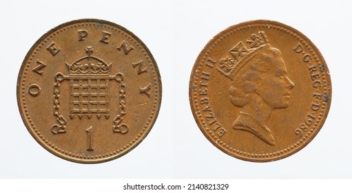 UNITED KINGDOM - CIRCA 1986: One penny coin from United Kingdom showing a portrait of Queen Elizabeth II and a crowned portcullis with chains above the denomination "1"  - Shutterstock ID 2140821329