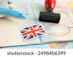 United Kingdom flag with approved Stamp visa and passport document to immigration at airport in country.