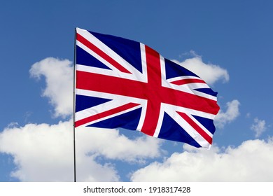 United Kingdom flag isolated on the blue sky with clipping path. close up waving flag of United Kingdom. flag symbols of United Kingdom.