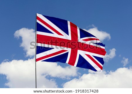 United Kingdom flag isolated on the blue sky with clipping path. close up waving flag of United Kingdom. flag symbols of United Kingdom.