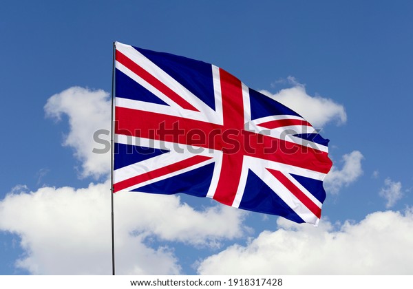United Kingdom flag isolated on the blue sky\
with clipping path. close up waving flag of United Kingdom. flag\
symbols of United\
Kingdom.