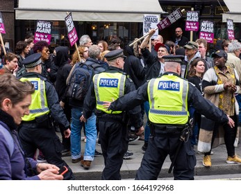 United Kingdom, London - April 01 2017: Policemen wearing hi viz vests control a crown of protesters during a march in London Central.
