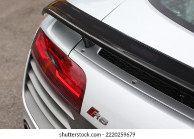 United Kingdom, Manchester April 2021.The Rear Section Of A 2013 Audi R8 V10 Plus With Optional Carbon Fibre Rear Wing And Red R8 Rear Badge With LED Rear Lights