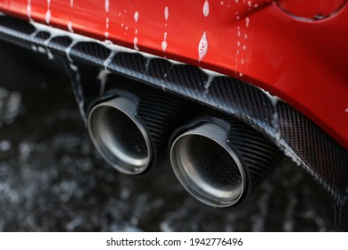 United Kingdom, Manchester March 2021. The Optional BMW Carbon Fibre Rear Diffuser And Exhaust Tips With Dripping Car Soap On A 2015 BMW M4 F83 Cabriolet 