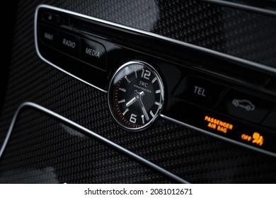 United Kingdom, Manchester November 2021. An IWC Clock Inside The Red Carbon Fibre Centre Console Interior Of A 2015 Mercedes Benz C63s AMG Edition 1 