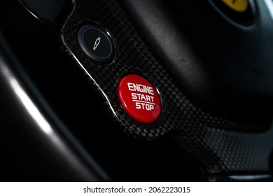 United Kingdom, Manchester October 2021. A 2015 Ferrari 488 GTB Red Engine Start Stop Button With Carbon Fibre Steering Wheel Surround On The Multi Function Carbon Fibre Steering Wheel