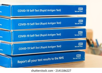 UNITED KINGDOM - March 26, 2022. COVID-19 Self-test (Rapid Antigen Test), NHS Trace And Test. Stack Of Covid LFT Tests, Testing Kits, Boxes, NHS Trace And Test, UK