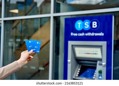 United Kingdom, Newcastle, May 27, 2022: A Woman's Hand Holds A New TSB Bank Card, Against The Background Of An ATM. Bank Card With A Chip And Contactless Payment.