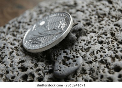 United Kingdom silver coin 2 pounds Britania. Silver coin on stones. Pure silver Investment coin.  - Shutterstock ID 2365241691